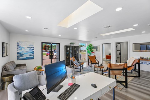 A modern office with a large desk and a computer monitor.