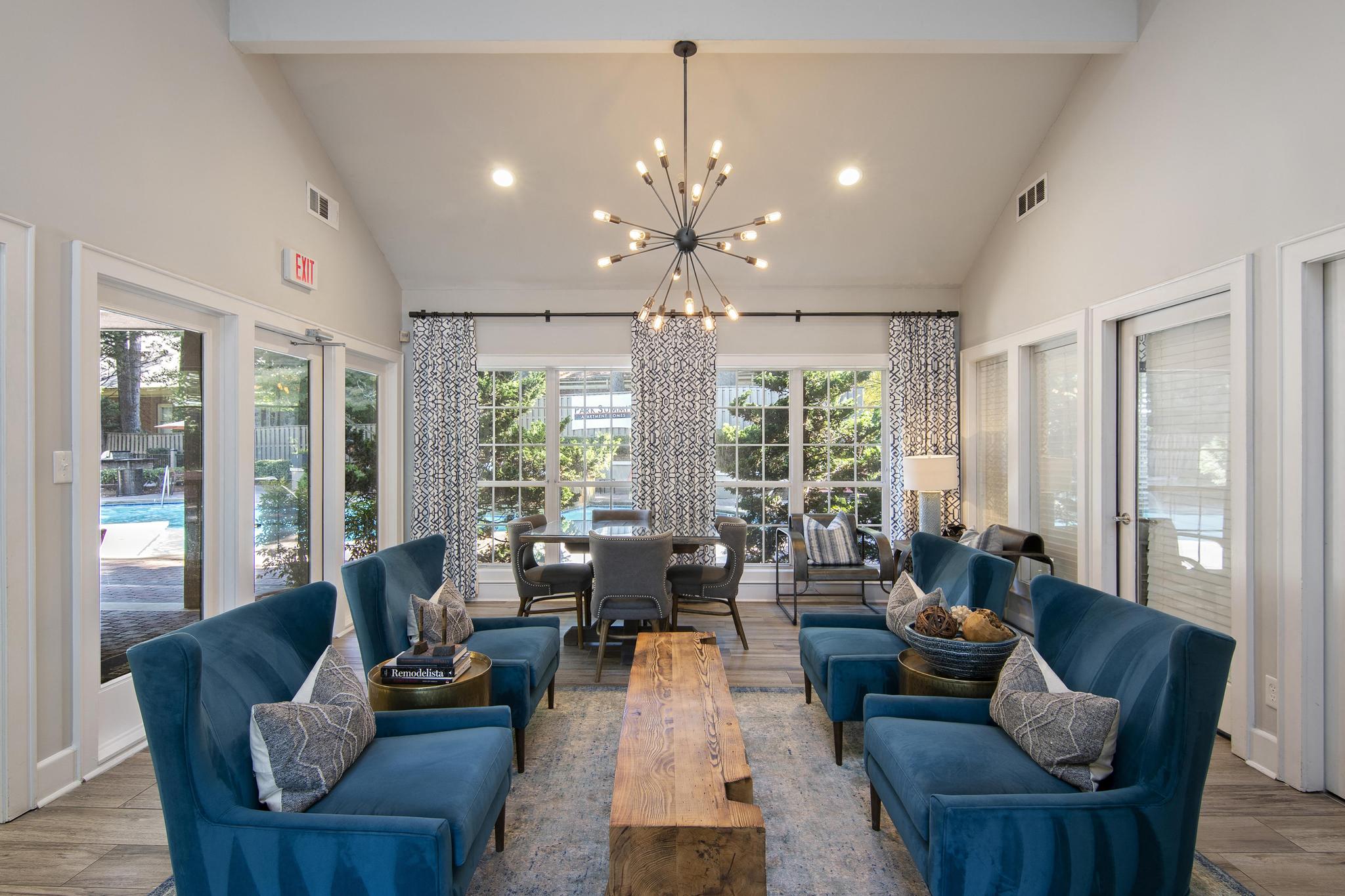 a living room with blue couches and a chandelier