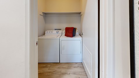 A small laundry room with a washer and dryer.