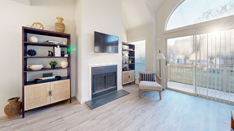 A living room with a fireplace and a TV mounted on the wall.
