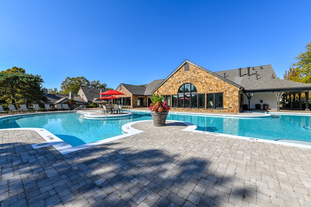 Revitalizing Resort Style Swimming Pool with Relaxation Space and Seating Area at Pointe Royal Townhome Apartments, Overland Park, KS 66213