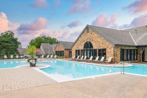 Enjoy our beautiful outdoor swimming pool and sundeck with chairs at Pointe Royal in Overland Park, KS