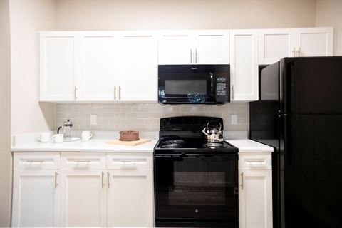 Cabinetry and Black Appliances in Kitchen at Polos at Hudson Corners Apartments, South Carolina 29650