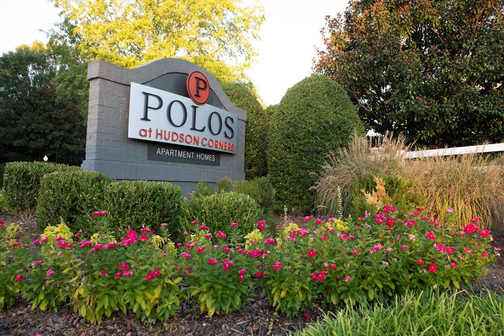 Entrance Signage with flowers at Polos at Hudson Corners Apartments, South Carolina 29650