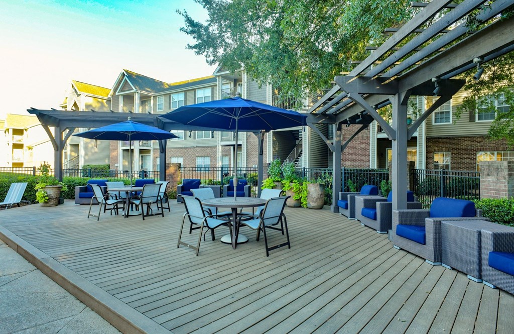 Sundeck with Tables, Chairs, and Cushioned Seating at Polos at Hudson Corners Apartments, South Carolina 29650