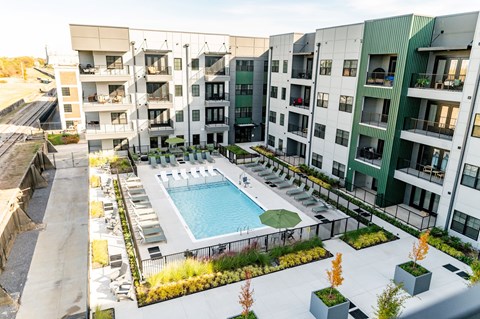 A swimming pool is surrounded by apartment buildings at Harbor Side at Conwood Flats Apartments, Memphis, TN, 38107
