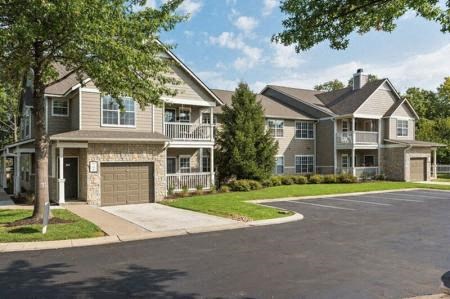 Building with lawn and trees at Sandstone Creek Apartments , Overland Park, KS