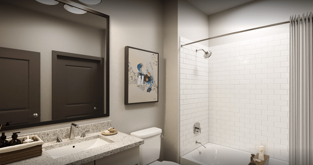 a bathroom with a sink and a mirror and a shower and a toilet at Livano Prosper, Prosper, TX