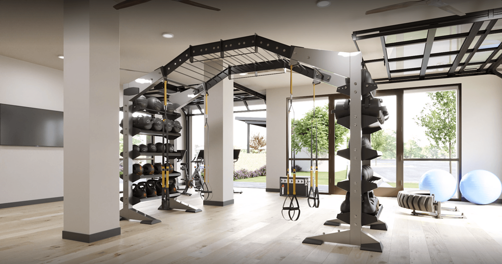 a gym with a large number of fitness equipment and large windows at Livano Prosper, Texas