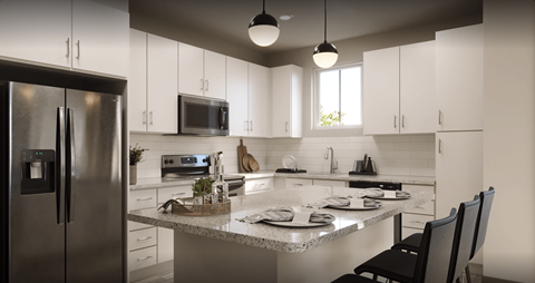 a kitchen with white cabinets and a granite counter top at Livano Prosper, Prosper, 75078