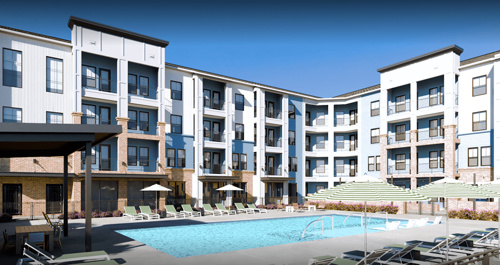 a swimming pool with chairs and umbrellas in front of an apartment building at Livano Prosper, Texas, 75078