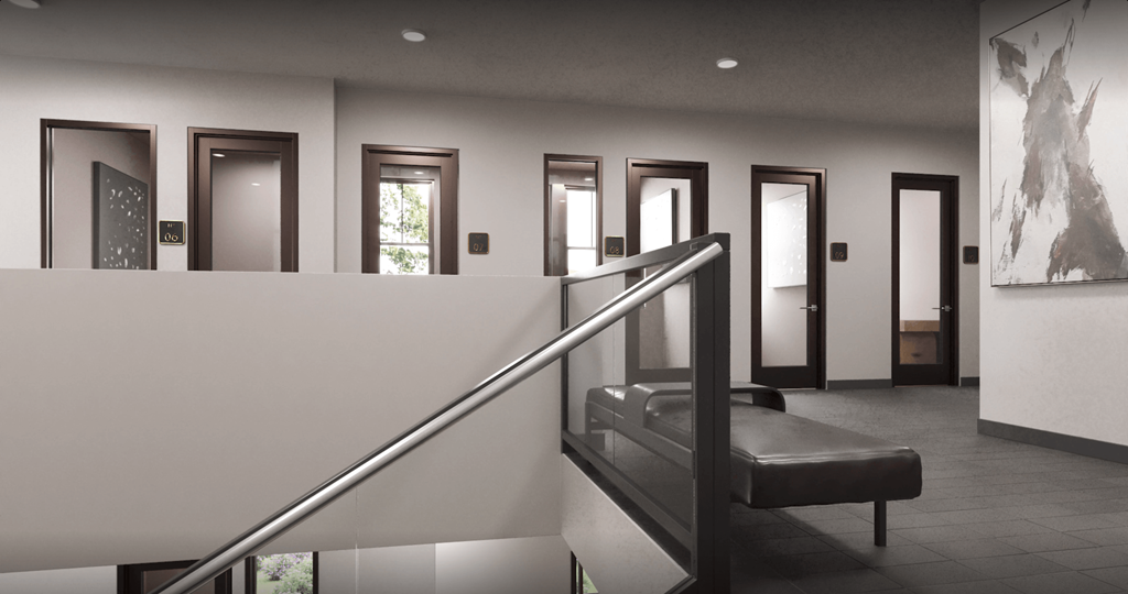 a stairway in a building with a black railing and a white wall with doors at Livano Prosper, Texas, 75078