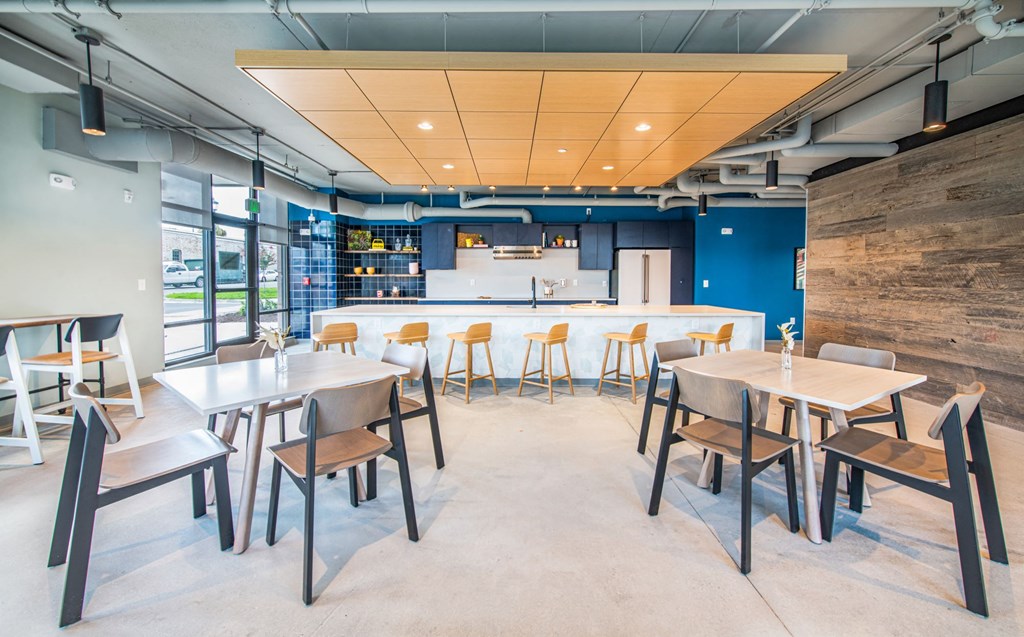 a dining room with tables and chairs and a bar
