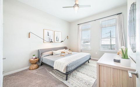 a bedroom with a bed and two windows at The Baxly, Georgia
