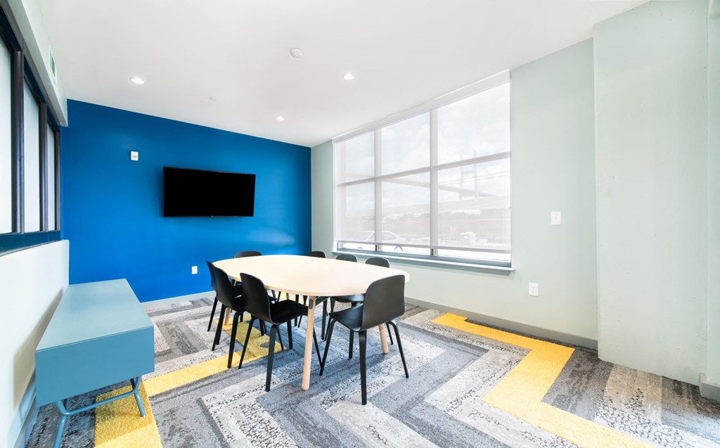 a conference room with a table and chairs and a large window
