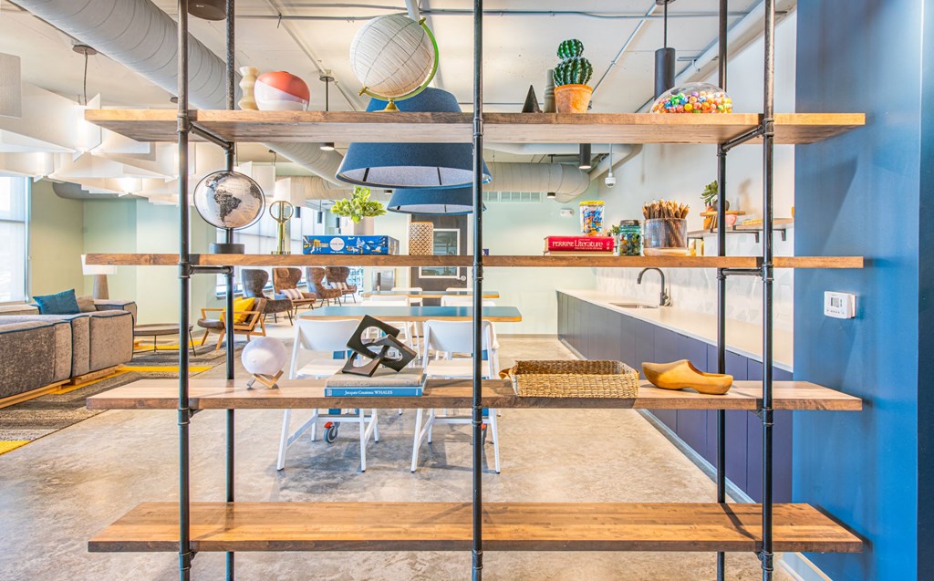 a living room with a table and shelves