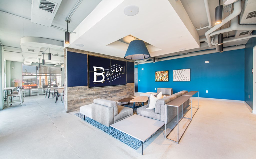 a living room with a blue wall and a couch and a table