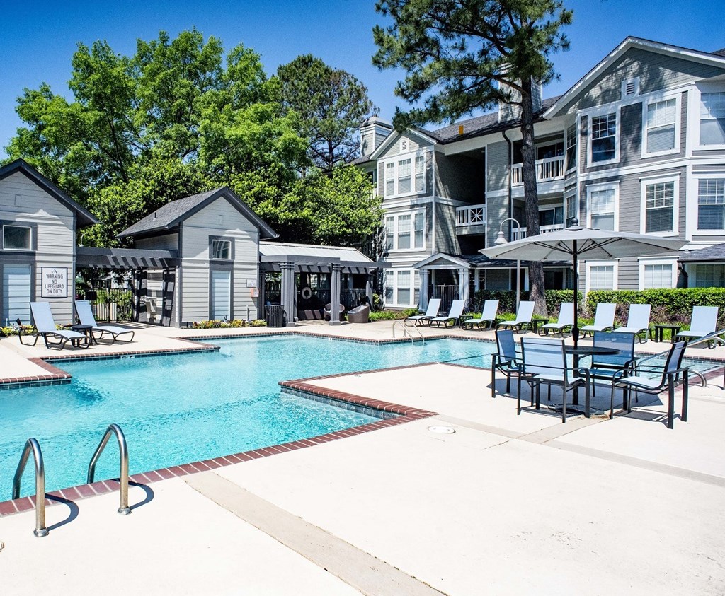 the resort style pool with chairs and tables at the preserve at ballantyne commons