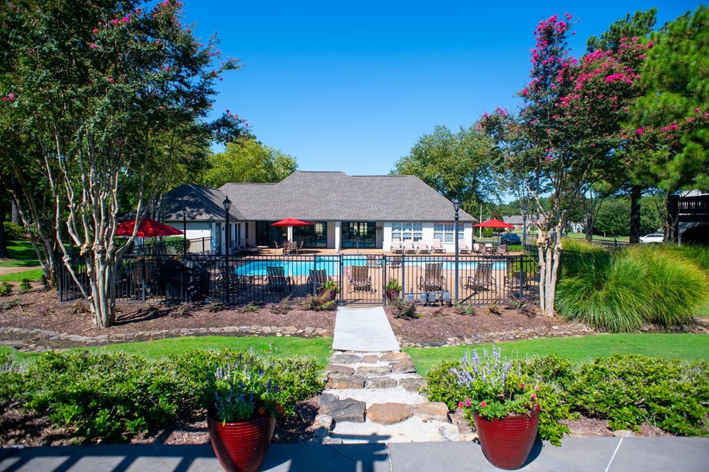 the view of a pool with a house at Collierville, Collierville, Tennessee in the background