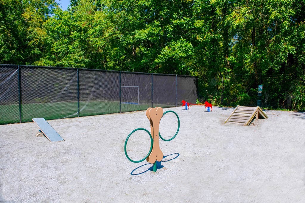 a playground with two tennis rackets and two kids playing in the background  at Grove Point, Georgia, 30093