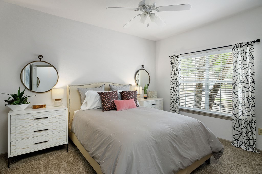 Model bedroom with ceiling fan at  Sandstone Creek Apartments Overland Park KS