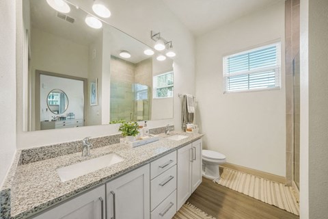 a bathroom with a large mirror and two sinks at Livano Springdale, Kentucky, 40241