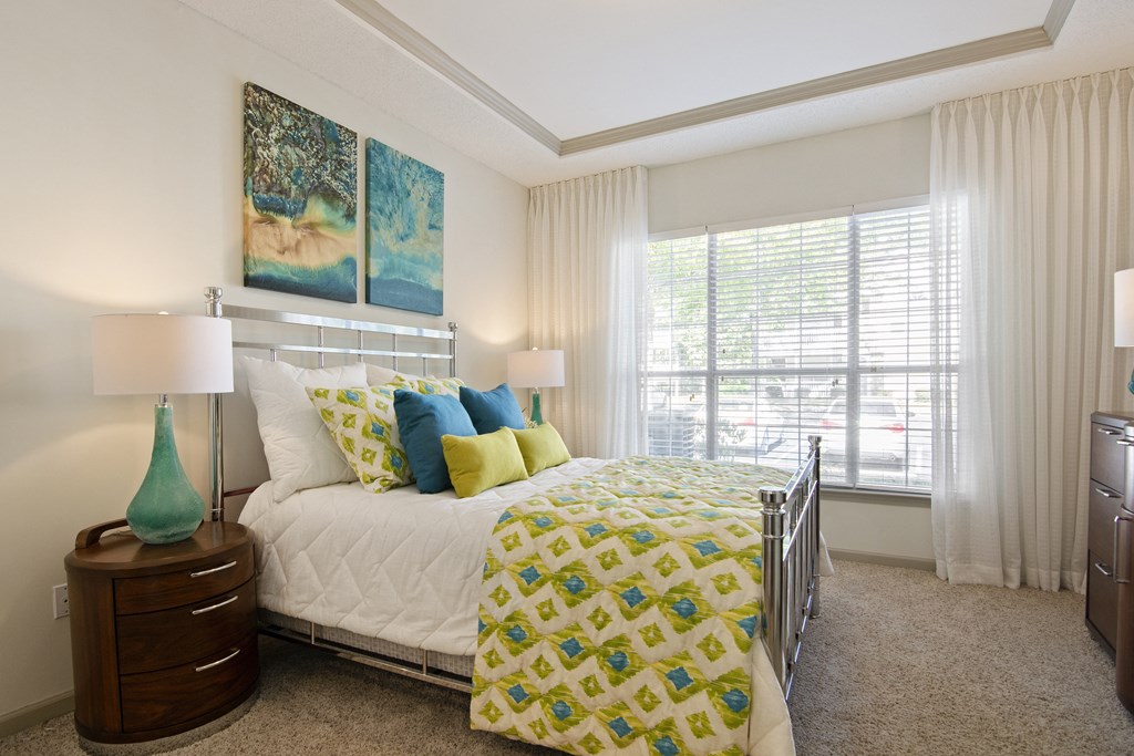 Bedroom in Model Apartment with Large Window Bedroom in Model Apartment with Large Window located at St. Andrews Apartments in Johns Creek, GA 30022