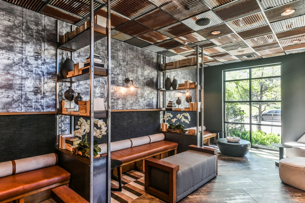 a living room with leather furniture and a large window