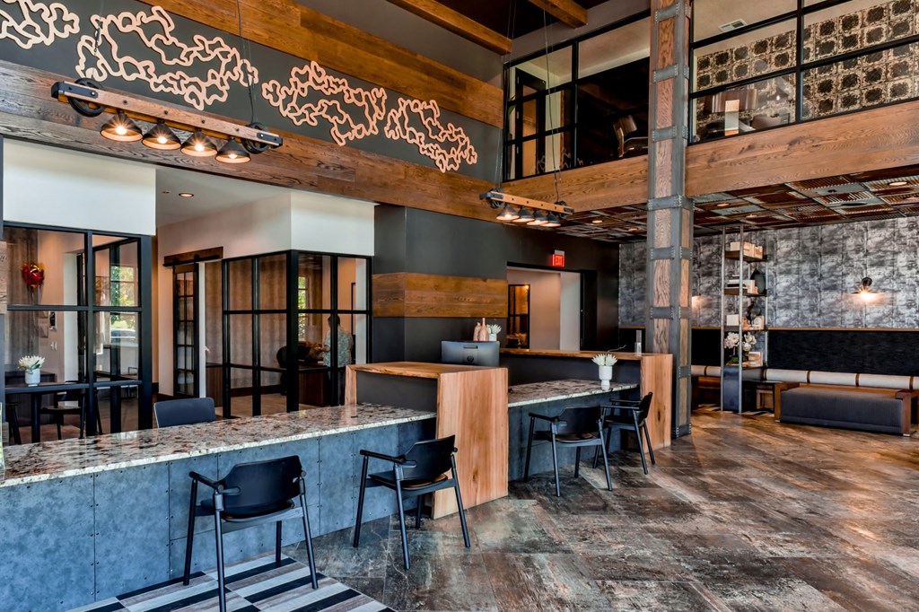 the lobby of a restaurant with a bar and tables