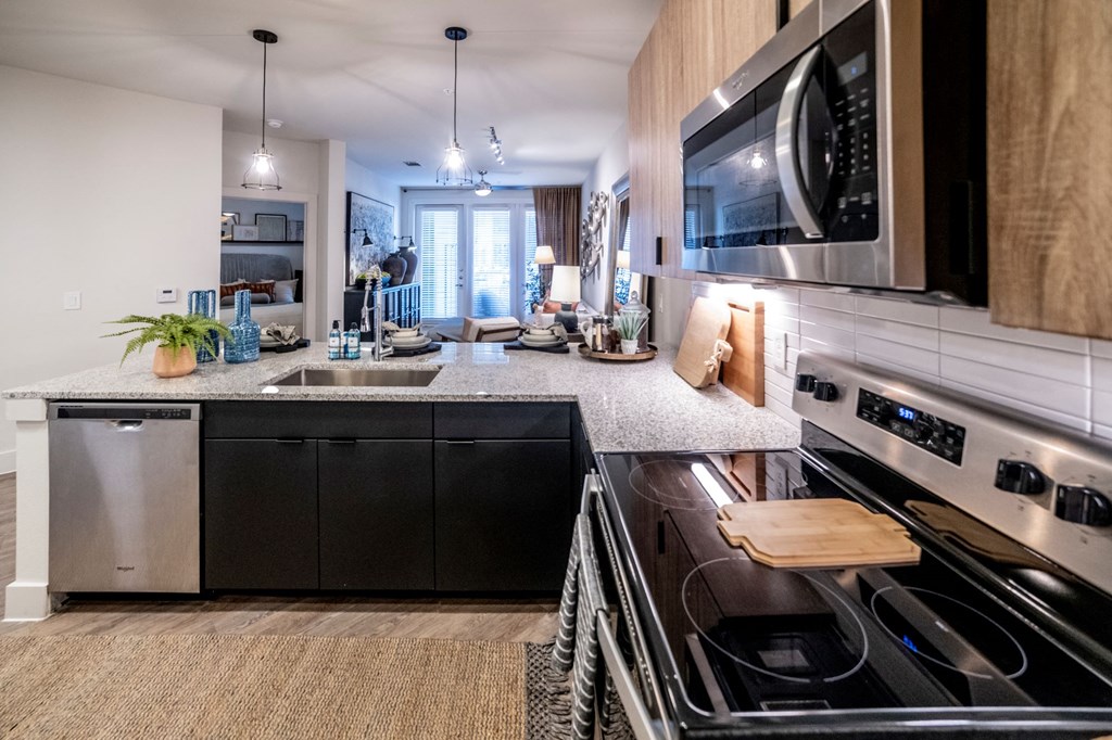 open floorplan kitchen with island and updated appliances at Station at Old Town, Lewisville, 75057
