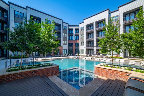 a swimming pool in front of some apartment buildings