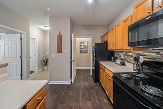Galley Kitchen leading to laundry room at Sugarloaf Crossings Apartments in Lawrenceville, GA 30046 - Photo Gallery 2
