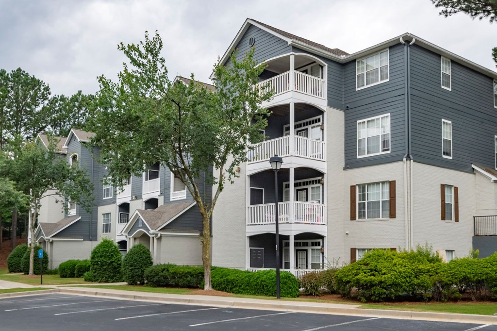 A large apartment building with a grey and white exterior.