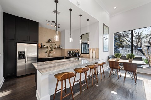A modern kitchen with a large island and bar stools. at The Ambrose, Texas