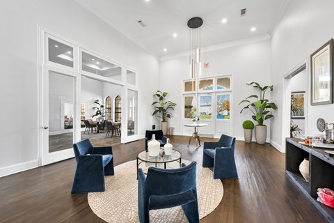 A living room with a glass door leading to a dining area. at The Ambrose, Houston
