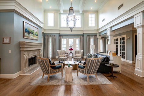 A living room with a fireplace and a painting on the wall.