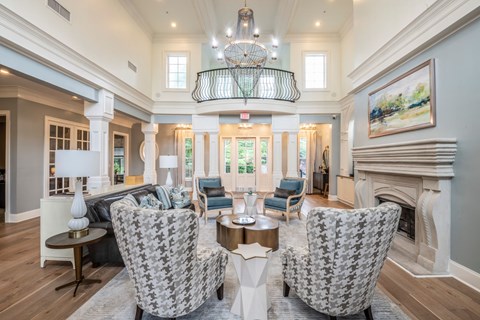 A living room with a fireplace and a chandelier.