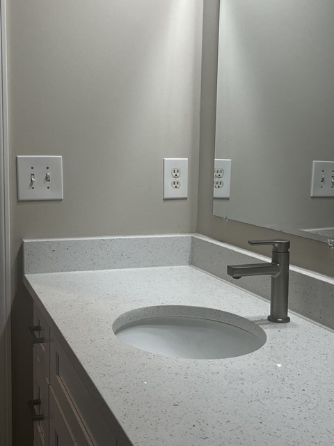 a sink and mirror in a bathroom at The Berkeley Apartments, Georgia, 30096