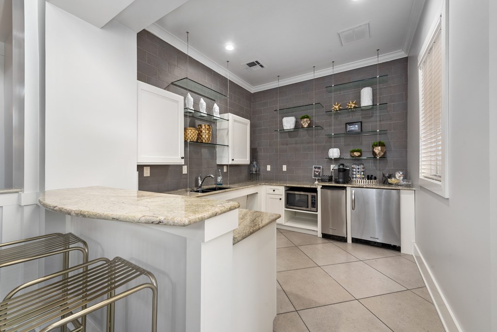 A kitchen with white cabinets and a marble countertop. A kitchen with white cabinets and a marble countertop at The Fenwick Apartments, Humble, TX, 77396