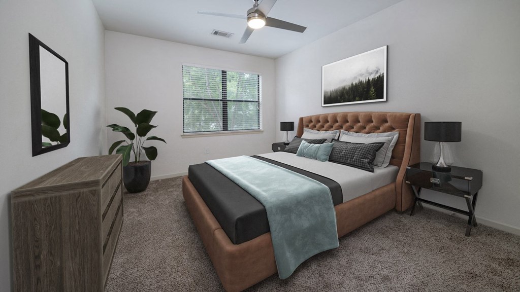 The Hendrix Apartments bedroom with bed and ceiling fan at The Hendrix, Atlanta