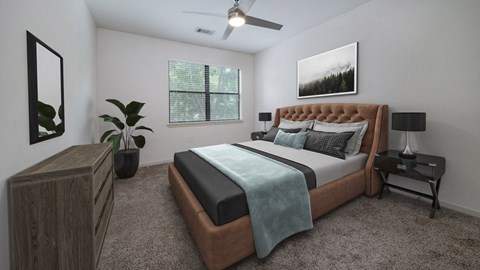 The Hendrix Apartments bedroom with bed and ceiling fan at The Hendrix, Atlanta