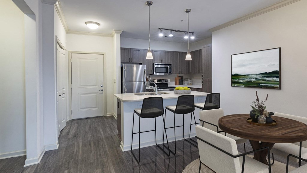 The Hendrix Apartments an open kitchen and dining area with a table and chairs at The Hendrix, Atlanta, GA