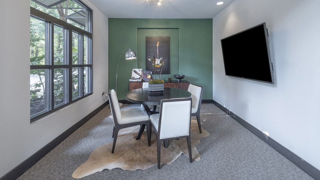 a dining room with a table and chairs and a television at The Hendrix, Atlanta, GA, 30329