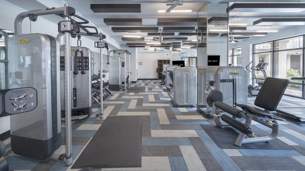 a large fitness room with cardio machines and weights at The Hendrix, Georgia, 30329
