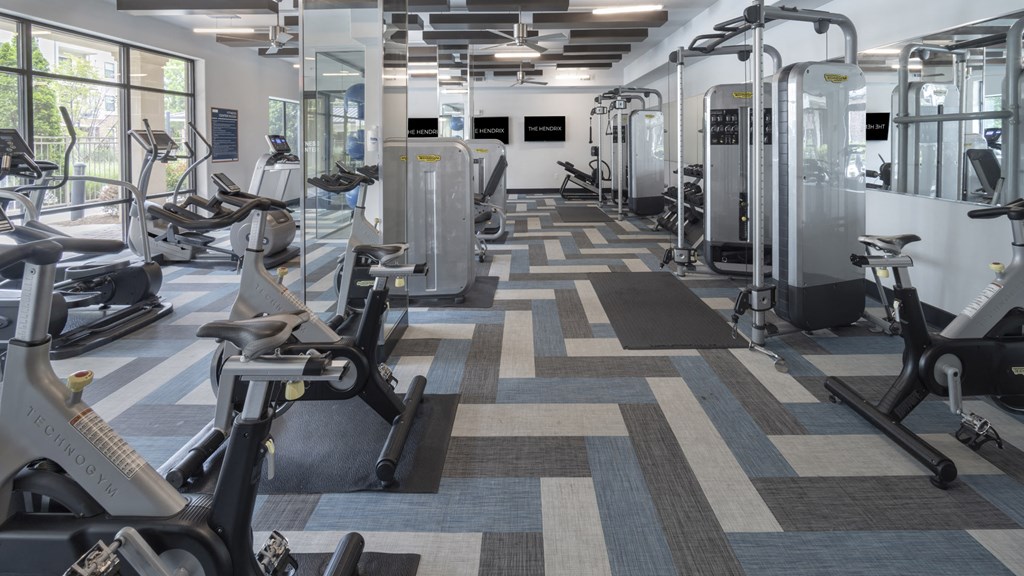 a fitness room with cardio machines and other exercise equipment at The Hendrix, Atlanta, GA, 30329