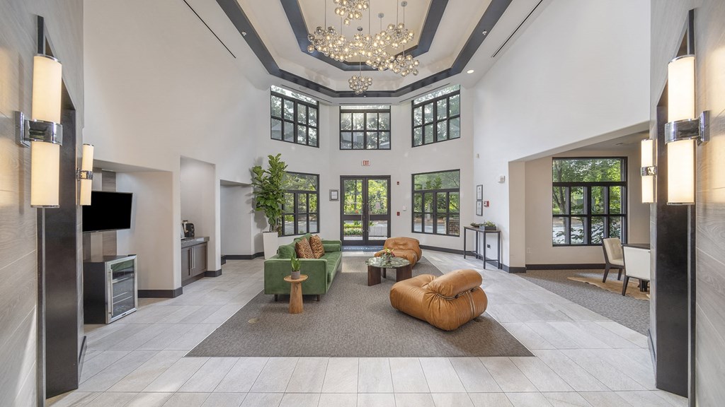 a large lobby with furniture and a chandelier at The Hendrix, Atlanta