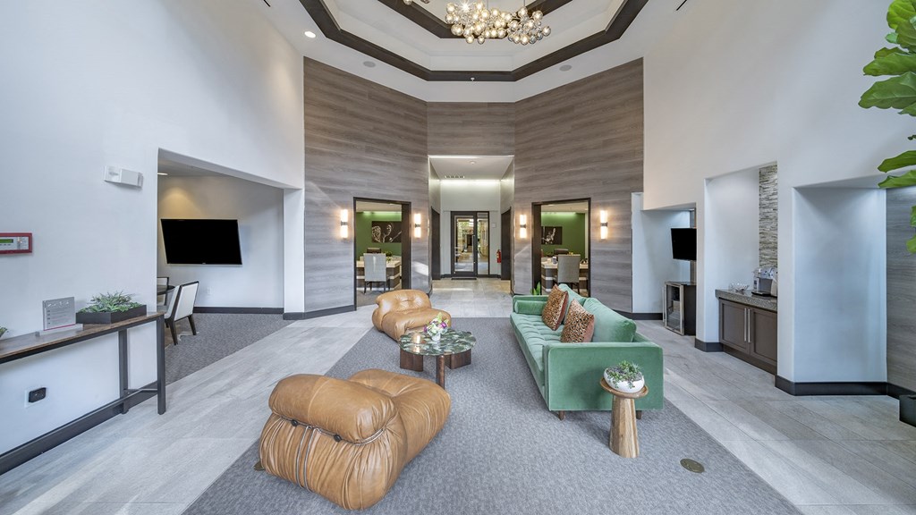 the lobby of a hotel with couches and a reception desk at The Hendrix, Atlanta, GA
