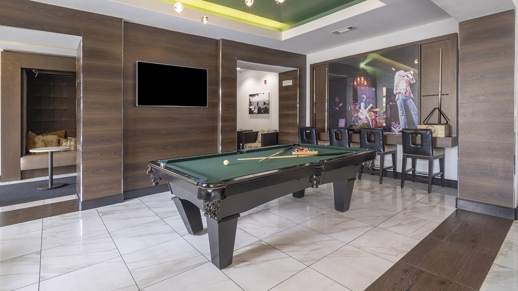 a billiards table in a game room with a tv at The Hendrix, Atlanta, Georgia