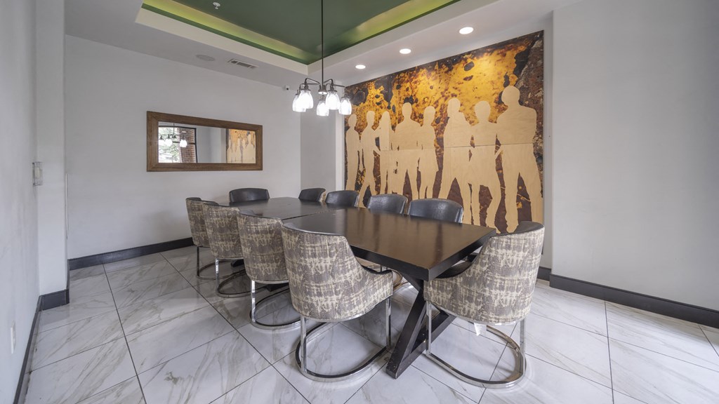a conference room with a long table and chairs and a mural on the wall at The Hendrix, Atlanta, GA