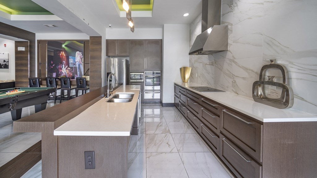 a large kitchen with marble counter tops and a dining room with a table and chairs at The Hendrix, Atlanta, GA, 30329